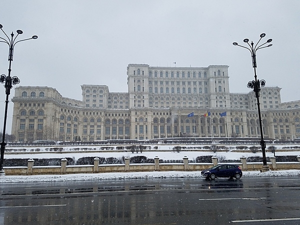 Exterior of the Palace of the People in Bucharest. The building was constructed between 1984 and 1997 on orders of Nicolae Ceausescu, the dictator of communist Romania. The structure is the world's third-largest building by floor area (after the Pentagon in Washington, DC and the Long'ao Building in China) with 1,100 rooms; it consists of 12 floors above ground and 8 floors below. The edifice hosts the two houses of Romania's Parliament (the Senate and the Chamber of Deputies), three museums, and an international conference center. Nonetheless, about two-thirds of the building remains unoccupied.