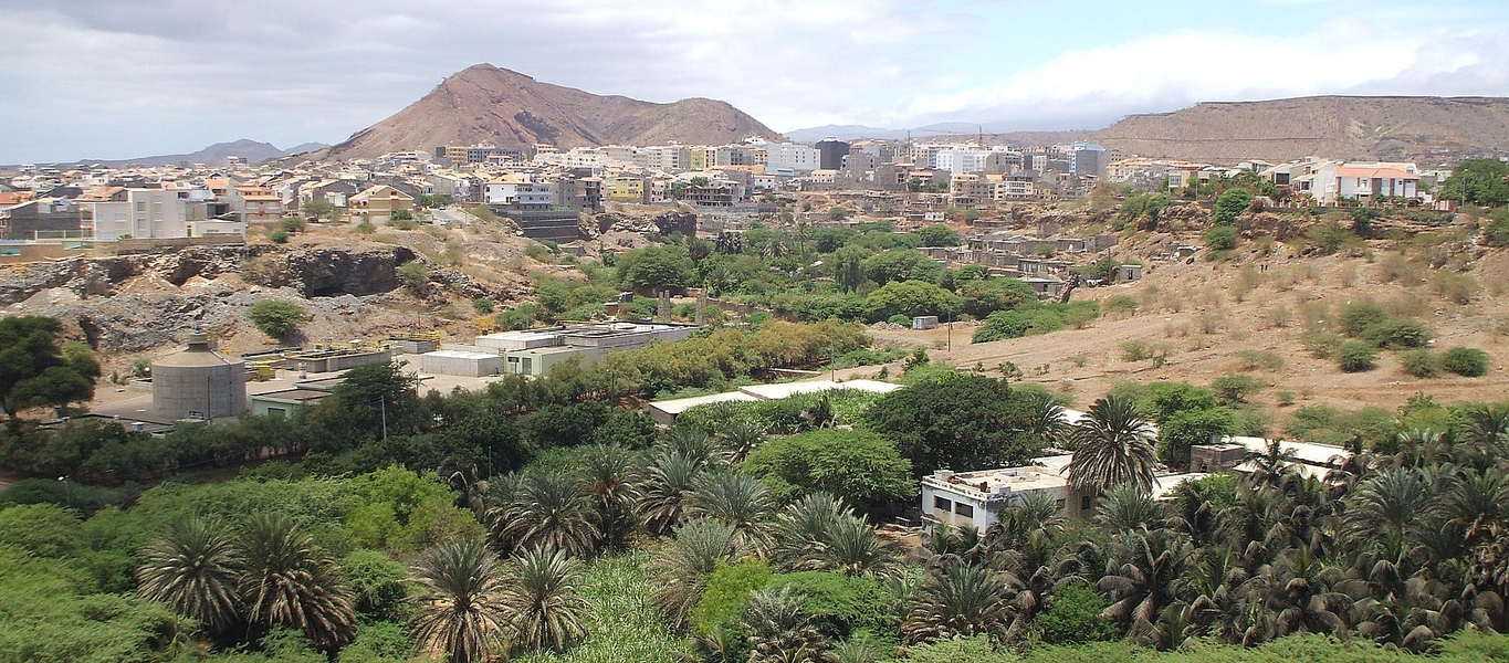 A panoramic view of Palmarejo, a subdivision of Praia, with Monte Vermelho in the background. The exact date of Praia's founding is unclear, but it was sometime in the 16th century. Praia attained the status of a city, as well as its designation as the capital of Cabo Verde, in 1858; it is the economic, political, and cultural center of Cape Verde.