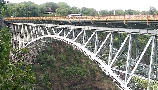 The Victoria Falls Bridge over the Zambezi River between Zimbabwe and Zambia. The bridge links the two countries and has border posts at both ends, at the towns of Victoria Falls, Zimbabwe and Livingstone, Zambia.