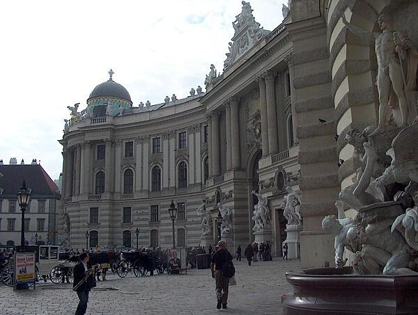 The Michaelertrakt (Michael&apos;s Wing) of the Hofburg (Imperial Palace) was designed by renowned Austrian architect Joseph Emanuel Fischer von Erlach in 1726, but not actually constructed until 1889-1893. The fountain, called "Power on Land," is on the right.