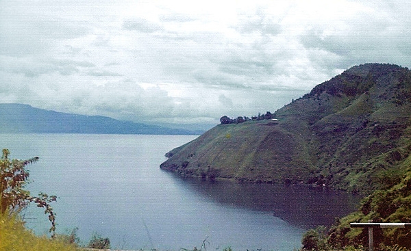 Lake Toba (pictured) is located in the north of the island of Sumatra and occupies the caldera of a supervolcano. The lake is about 100 km (62 mi) long, 30 km (19 mi) wide, and up to 505 m (1,657 ft) deep. It is the largest lake in Indonesia and the largest volcanic lake in the world.