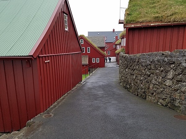 Early timber buildings have survived in the Tinganes area of Torshavn, Faroe Islands, which contains government offices and shops. Tinganes is the historic site of the Faroese landsstyri (government); the name means "parliament jetty" or "parliament point" in Faroese.