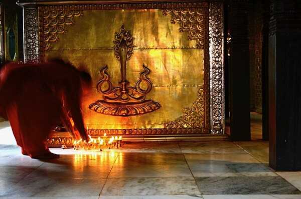 In Buddhism, symbolic offerings are made to increase contemplative gratitude and inspiration, and often act as preparation for meditation. Typical material offerings involve simple objects such as a lit candle or oil lamp, burning incense, flowers, food, fruit, water, or drinks.  Within the traditional Buddhist framework of karma and rebirth, offerings contribute to the accumulation of merit, which leads to a better rebirth and eventual release from suffering. Candles mark respect or deference, and evoke the state of impermanence and change; these are cornerstones of the Buddhist philosophy. The light from a humble candle is also said to symbolize the enlightenment of the Buddha.