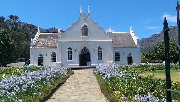 Franschhoek (Afrikaans for "French Corner") is a small town in Western Cape Province and one of the oldest towns in the Republic of South Africa. Settlement by French Huguenot refugees began in 1688 and many of their original farms are today renowned wineries. The town, at the very heart of the South African wine industry, still retains much of its historic Dutch Cape-style architecture, including this much photographed Dutch Reformed Church.