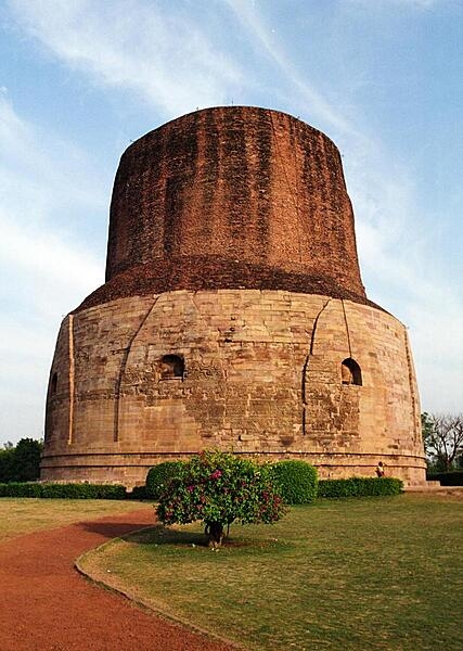The Dhamek Stupa located in Sarnath, India, is the location where the Buddha preached his first sermon to his first five disciples. Originally constructed in 249 B.C. by Emperor Ashoka of the Maurya Dynasty in an effort to spread Buddhism, it was replaced in A.D. 500. The cylindrically shaped Dhamek Stupa was built of red bricks and stones and stands 43.5 m (143 ft) and is 28 m (92 ft) wide, with carvings of flowers, birds, and humans on the walls. For Buddhists, the Dhamek Stupa is one of the four most sacred places associated with Buddha.