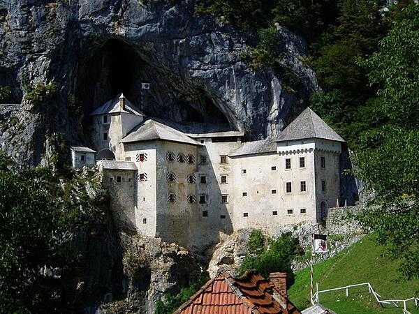 Predjama Castle is built on one of the world’s most unusual sites for a fortification, in the mouth of a cave complex that is halfway up a 123 m (400 ft) vertical cliff face in southwest Slovenia. The first two castles on the site were destroyed in a siege and an earthquake, respectively. In 1570, the present Renaissance-style structure was built below the original medieval castle.