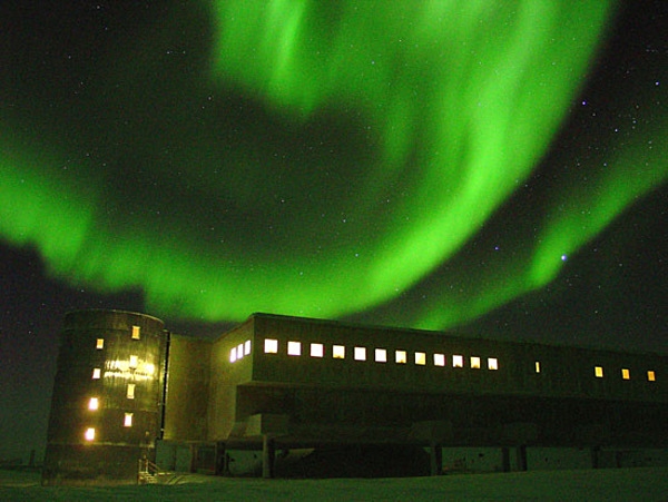 The aurora australis — the Southern Lights — as seen over the National Science Foundation's Amundsen-Scott South Pole Station. The eerie visual effect arises when charged particles blown off by the sun (the solar wind) are caught in the Earth's magnetic field and travel along the field lines, colliding with molecules of oxygen and nitrogen in the atmosphere. Image courtesy of the National Science Foundation, Jonathan Berry.