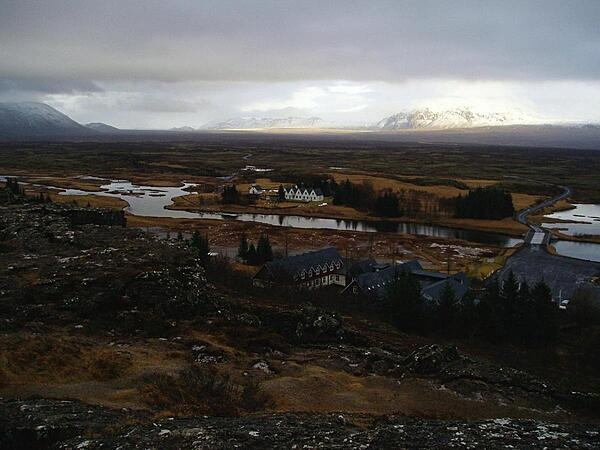 Photo taken from the Eurasian continental plate (foreground rock ledge) looking across to the North American plate and to the Thingvellir, where the Icelandic republic was founded in 930 and independence declared in 1944. The tabletop mountain on the horizon was formed by a volcanic eruption beneath a glacial ice sheet.