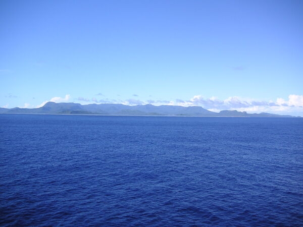 A view of the ocean approach to Pohnpei Island in Micronesia, and the high volcanic topography of the island. To the right you can make out Paipalap Peak (Sokehs Rock), which overlooks Pohnpei harbor.