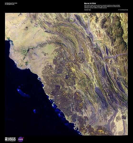 Dark-colored volcanic cones sprout from an ancient lava field in this high-resolution satellite photo. The field, known as Harrat Al Birk, covers 1,800 sq km (700 sq mi) and is the only volcanic field along Saudi Arabia&apos;s Red Sea coastline. However, many such lava fields dot the Arabian Peninsula and can range in age from 2 million to 30 million years old. Image courtesy of USGS.