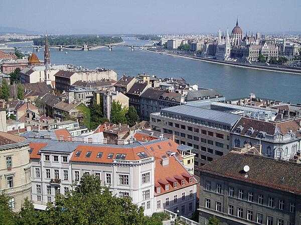 A view of the Danube River that splits Buda and Pest (the two halves of the city of Budapest, Hungary), as seen from Buda; the Parliament Building is visible in the distance.