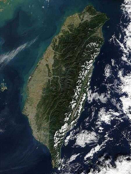 The island of Taiwan is mostly mountainous in the east, but gradually transitions to gently sloping plains in the west. At the northern tip of the island is Taiwan's capital city, Taipei, which appears as a large grayish patch surrounded by dark green. In this image, most of Taiwan's eastern coast is dotted with low clouds, with low and high clouds over the Pacific Ocean. The imaging satellite also detected three fires, which are marked in red. Photo courtesy of NASA.