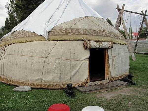 A typical Kyrgyz yurt: a portable shelter framed in bent wood and covered with layers of fabric, typically felt.