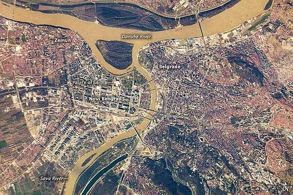 Belgrade, located at the confluence of the Danube and Sava Rivers,  is the capital of the Republic of Serbia. The core of old Belgrade - known as Kalemegdan - is located along the right banks of both the Danube and the Sava Rivers (image center). To the west across the Sava, Novi Beograd (New Belgrade) was constructed following World War II. The difference in urban patterns between the older parts of Belgrade and Novi Beograd is striking in this astronaut photograph from the International Space Station. Novi Beograd has an open grid structure formed by large developments and buildings such as the Palace of Serbia - a large federal building constructed during the Yugoslav period, now used to house elements of the Serbian Government. By contrast, the older urban fabric of Belgrade is characterized by a denser street grid and numerous smaller structures.

Other suburban and residential development (characterized by red rooftops) extends to the south, east, and across the Danube to the north. The location of Belgrade along trade and travel routes between the East and West contributed to both its historical success as a center of trade and its fate as a battleground. Today, the city is the financial center of Serbia, while Novi Beograd supports one of the largest business districts in southeastern Europe. Image courtesy of NASA.