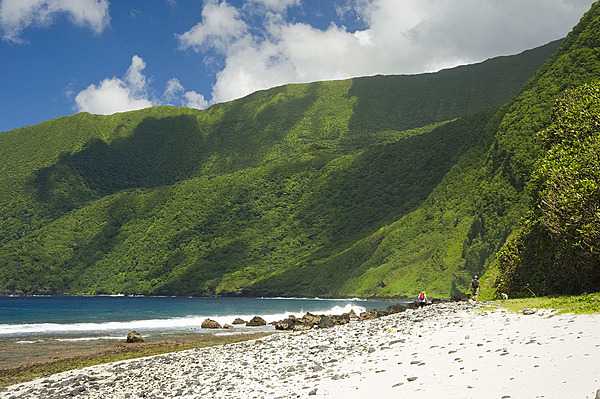 Si'u Point is a good place to view the south coast of Ta'u in American Samoa. Some of the tallest sea cliffs in the world stairstep over 900 m (3,000 ft) to the summit of Lata Mountain. Photo courtesy of the US National Park Service.