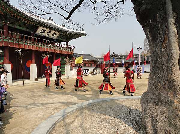 Procession in Hwaseong Fortress, or Suwon Hwaseong, in South Korea. Built between 1794 and 1796, the fortification surrounds the center of Suwon, the provincial capital of Gyeonggi-do. Located 30 km (19 mi) south of Seoul, the fortress includes a palace, Haenggung, and UNESCO designated both as a World Heritage site in 1997.