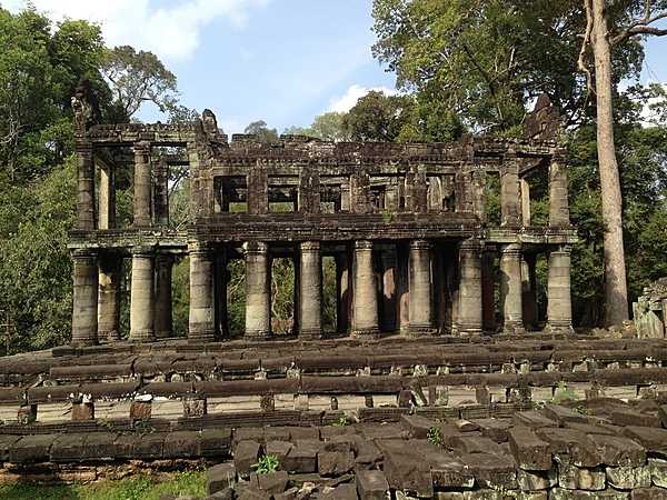 Preah Khan is a temple located northeast of Angkor Thom in Cambodia, built in the 12th century for King Jayavarman VII to honor his father. The purpose of this two-story building with round columns is unknown, but it is referred to as "the library."