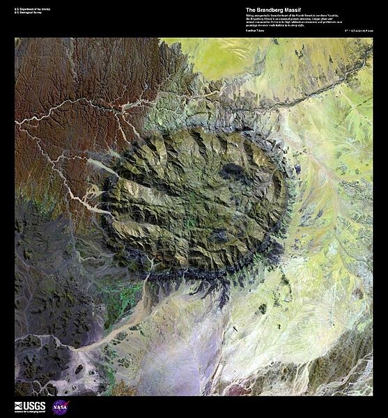 Rising unexpectedly from the heart of the Namib Desert, the Brandberg Massif, shown in this enhanced satellite image, is an exhumed granitic intrusion. As one of the highest mountains in Namibia at 2,573 m (8,439 ft), it formed when ancient magma chambers cooled and began to erode. Brandberg means fire mountain in Africaans, Dutch, and German. Unique plant and animal communities thrive in Brandberg&apos;s high-altitude environment, and prehistoric cave paintings decorate walls hidden in its steep cliffs, earning it status as a potential UNESCO World Heritage site. Image courtesy of USGS.