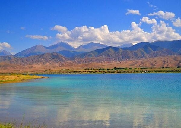 Issyk-Kul (Warm Lake) is an endorheic lake - it lacks any outflow to another body of water - in the Northern Tian Shan mountains in Eastern Kyrgyzstan. The lake is globally significant for its biodiversity of plant, animal, and bird species.  Issyk-Kul Lake is 182 km (113 mi) long, up to 60 km (37 mi) wide, and its area is 6,236 sq km (2,408 sq mi).