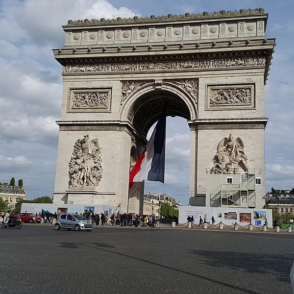 The Arc de Triomphe is one of the most famous monuments in Paris, standing at the western end of the Champs-Elysées at the center of Place Charles de Gaulle. The Arc de Triomphe honors those who fought and died for France in the French Revolutionary and Napoleonic Wars, with the names of French victories and generals inscribed on its inner and outer surfaces. Beneath its vault lies the Tomb of the Unknown Soldier from World War I.