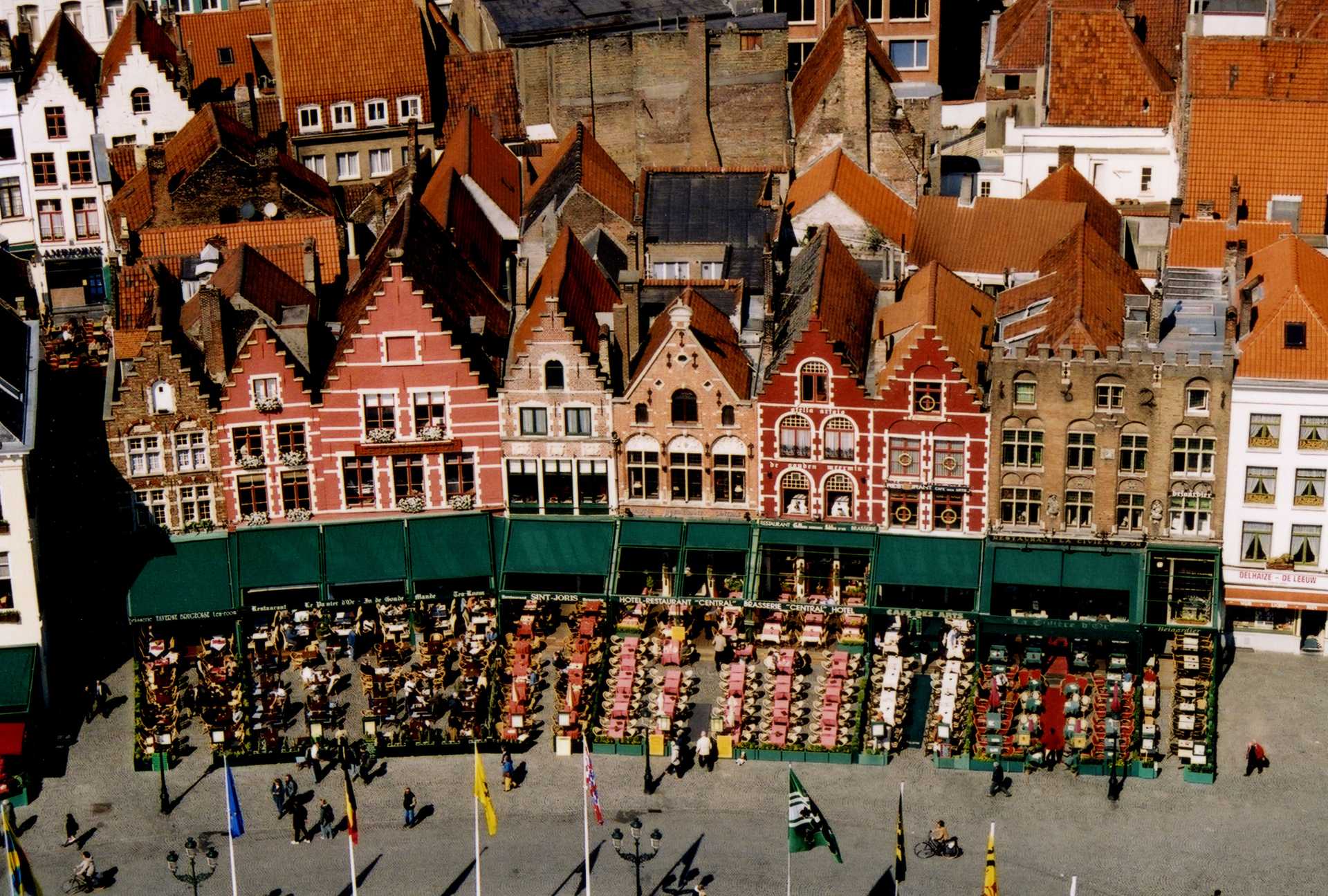 Outdoor cafes in the Market Square in Bruges (Brugge), Belgium, as seen from the Belfort, the city's medieval belfry.