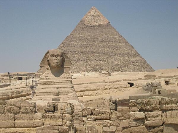 The Sphinx and the Pyramid of Khafre at Giza in Egypt. Unlike the pyramids, the Sphinx was not assembled piece by piece but was carved from a single mass of limestone.