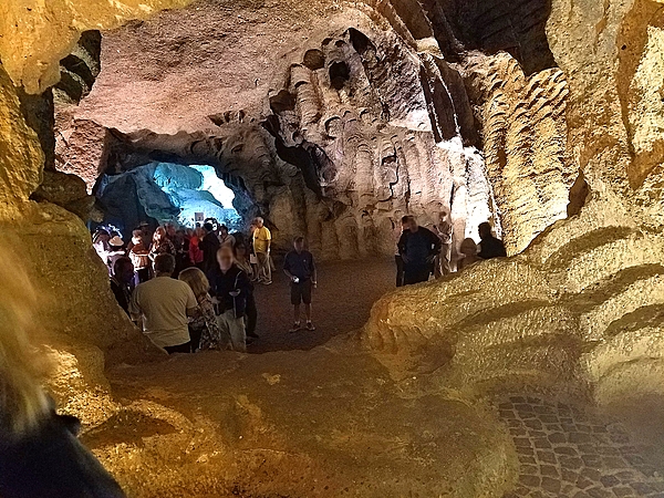 The interior of the Hercules Caves near Tangier.  At high tide, Atlantic Ocean waters flood the caves, which are part natural and part man-made. The man-made section was used in the past by Amazigh people to cut stone wheels from the walls to make millstones, thus expanding the caves considerably. The lower right shows evidence of the millstone cutting.