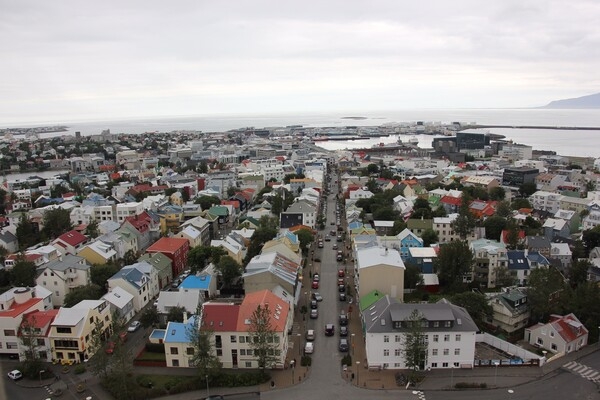 Reykjavík is the capital and largest city of Iceland, located on the southern shore of Faxaflói Bay. Steam from hot springs in the region is said to have inspired Reykjavík's name, which loosely translates to Smokey Bay.  Its latitude of 64°09' N makes it the world's northernmost capital city.