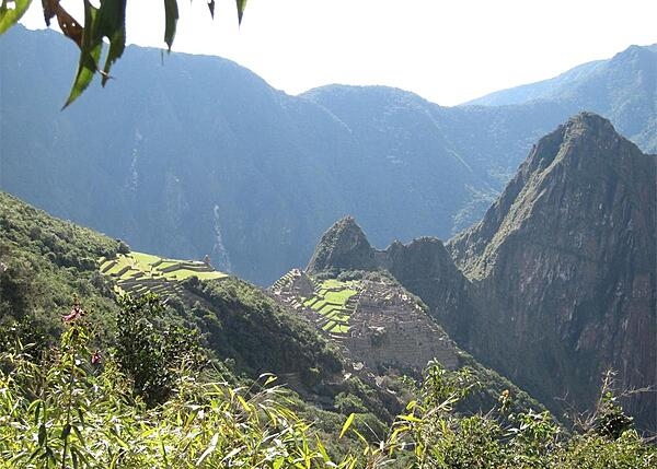 Machu Picchu (meaning “Old Mountain” in Quechua) in the foreground and Huayna Picchu (meaning “Young Mountain”) on the right are both mountains in Peru that rise above Machu Picchu, the city of the Incas.  The Incas built a trail up the side of Huayna Picchu and temples and terraces at its top. Huayna Picchu is 2,693 m (8,835ft) high, making it approximately 260 m (850 ft) taller than Machu Picchu.