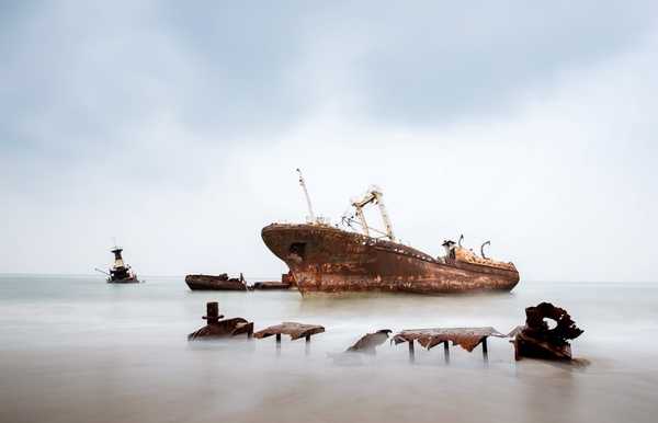 Located some 30 km north of Luanda, Angola's capital, is 2.5 km-long Shipwreck Beach. The area acquired its name in the 1970s when bankrupt companies towed their old ships to this remote beach, forming a ship graveyard. The ships date back to the 1960s; the largest of the more than 20 rusting hulks is an oil tanker named "Karl Marx."