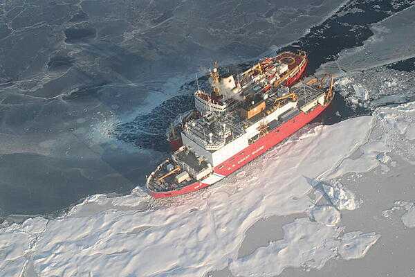 Helicopter view of Canadian Coast Guard ship Louis S. St. Laurent (top) and US Coast Guard cutter Healy (bottom) on the Arctic Ocean. This rendezvous took place during a scientific expedition to map the extended continental shelf in the Arctic Ocean. Photo courtesy of the US Geologic Survey/ Jessica K. Robertson.