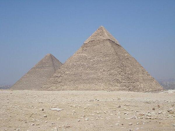 The Pyramids of Khufu (left) and Khafre on the Giza Plateau outside Cairo, Egypt. The former, also known as the Great Pyramid, is the largest of the pyramids and is the only one of the Seven Wonders of the Ancient World that still exists.