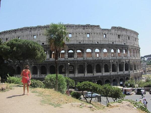 The Colosseum in Rome, Italy, was first used in A.D. 80.  In Roman times, it was called the Flavian Amphitheater and held 50,000 spectators. The name "Colosseum" was introduced in medieval times and referred to a giant statue of Nero that stood nearby.  The outer walls have three levels of arches with columns topped by Ionic capitals at the lower level and Doric and Corinthian at the top.