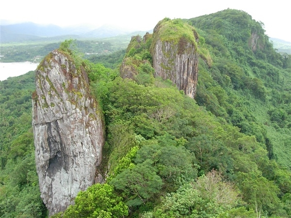 A prominent rock feature called the Ray of Light Spire, as seen from the top of Sokehs Rock on the island of Pohnpei in Micronesia. Photo courtesy of NOAA / Lt. Cmdr. Matthew Wingate.